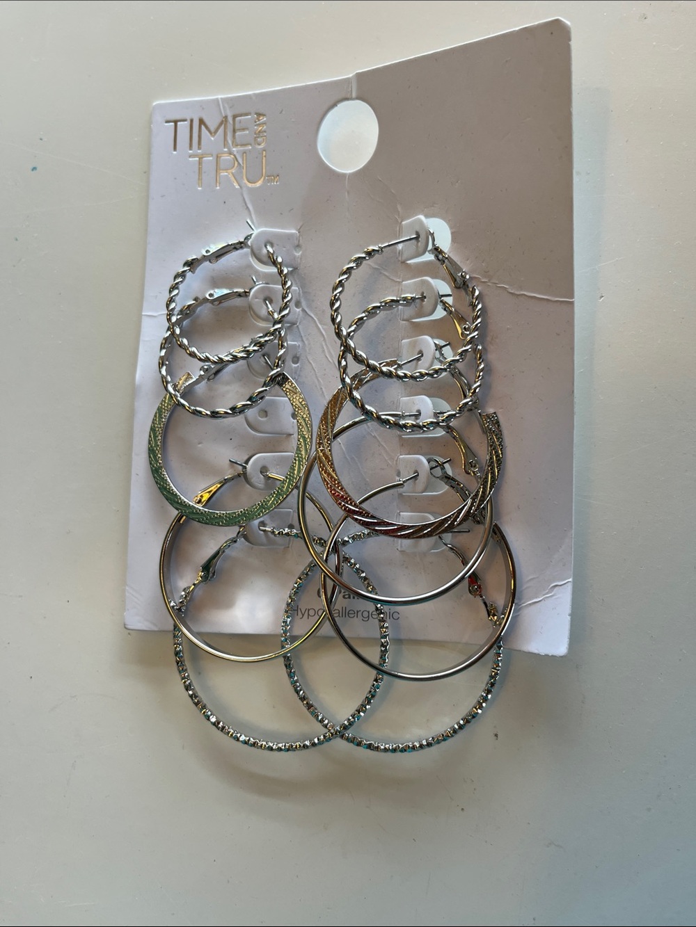 Five and a half pairs of silver tone hoop earrings